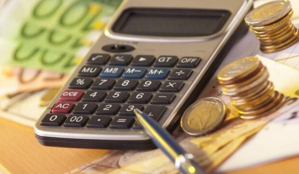 "European money on a table with calculator and coins, money and banking concept"