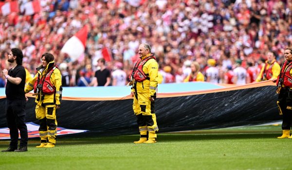 Arranmore's John Boyle holding the flag on the pitch before the match