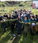 A ceremoinal  garland is split to offically open the New Biodiversity and Sustainable Garden at Gairmscoil Mhic Diarmada which Celebrates 35 Years of Education on Árainn Mhór Island 
Milestone Marked with a New Biodiversity and Sustainable Garden and New Website 
 Photo Clive Wasson