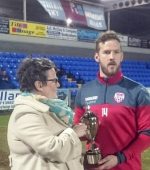 Former Derry City and Institute player Billy Kee's daughter presents the trophy to Derry City captain Ryan McBride