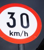An Irish 30 kmh speed sign in the dark night sky.