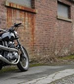 a-motorcycle-parked-in-front-of-a-brick-building-photo