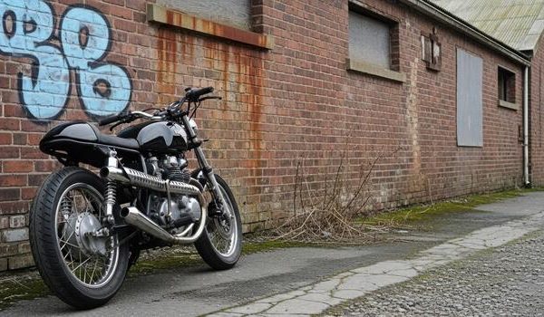 a-motorcycle-parked-in-front-of-a-brick-building-photo