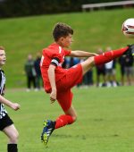 An acrobatic leap from Altrincham F.C. under-12's skipper Louie Skelton to win the ball during their match against St. Oliver Plunkett F.C.
