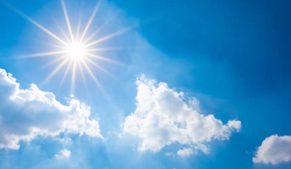 Sunny background, blue sky with white clouds and sun