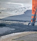 Worker in an orange uniform during a road repair