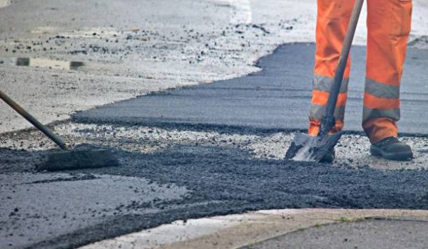 Worker in an orange uniform during a road repair