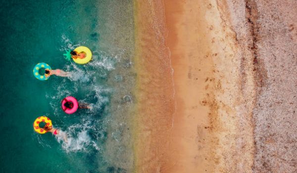 Aerial view of friends relaxing and having fun in the water