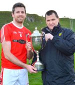 Donegal County Chairman Sean Dunnion presents St Michaels Christy Toye with the Donegal Senior League Division 1 Trophy at the Bridge.